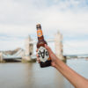 ZAG drinks bottle held out in someones hand in front of Tower Bridge